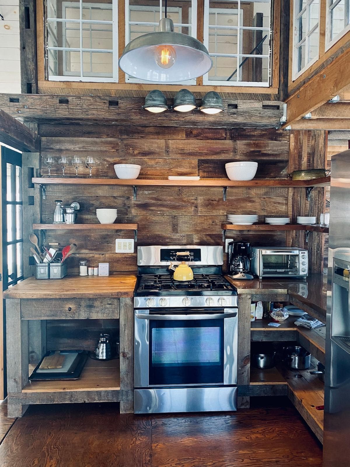 a well stocked kitchen.   many basic cooking necessities stored to the right of the stove.
